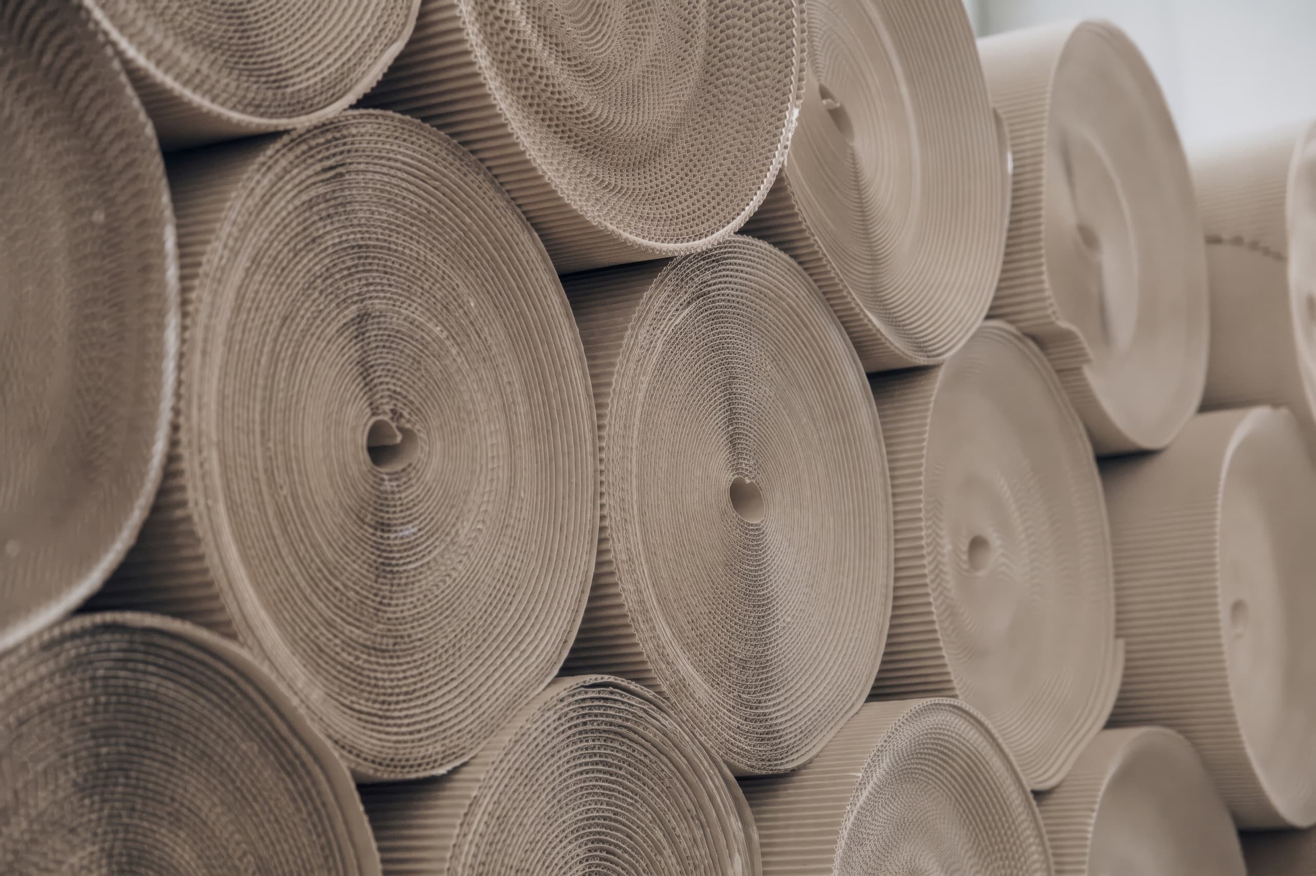 Rolls of corrugated cardboard stacked on top of each other